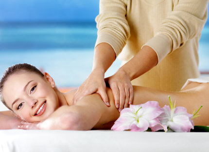 woman smiling while getting a massage